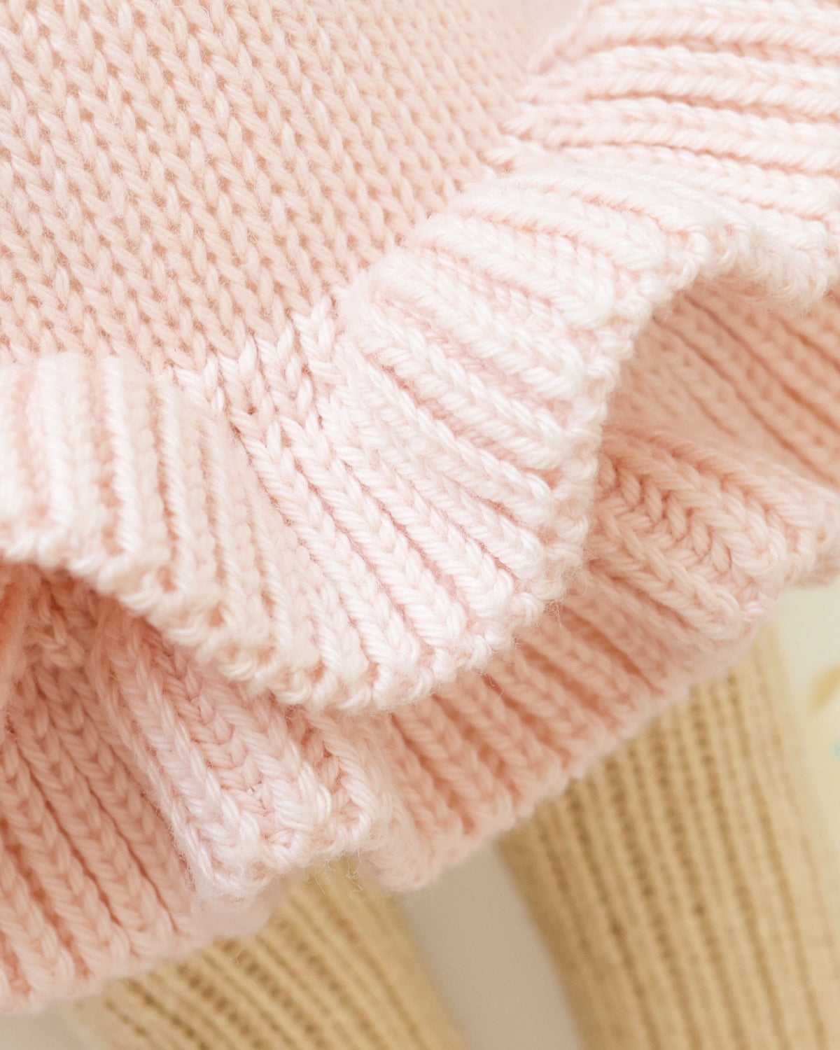Close-up of pink knitted fabric with a textured pattern
