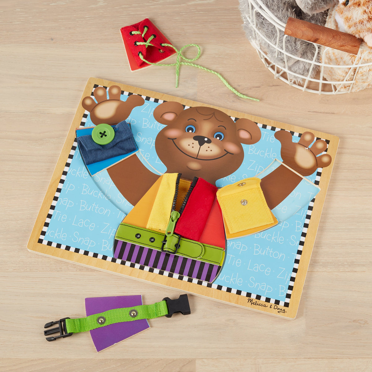 Educational toy board with bear character and various educational elements on brown background