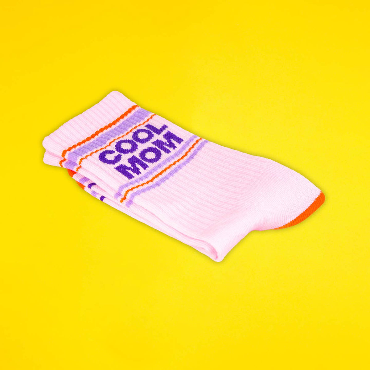 Pink socks with 'Cool Mom' text on a yellow background