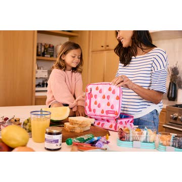 Woman and child preparing a lunch together in a kitchen.