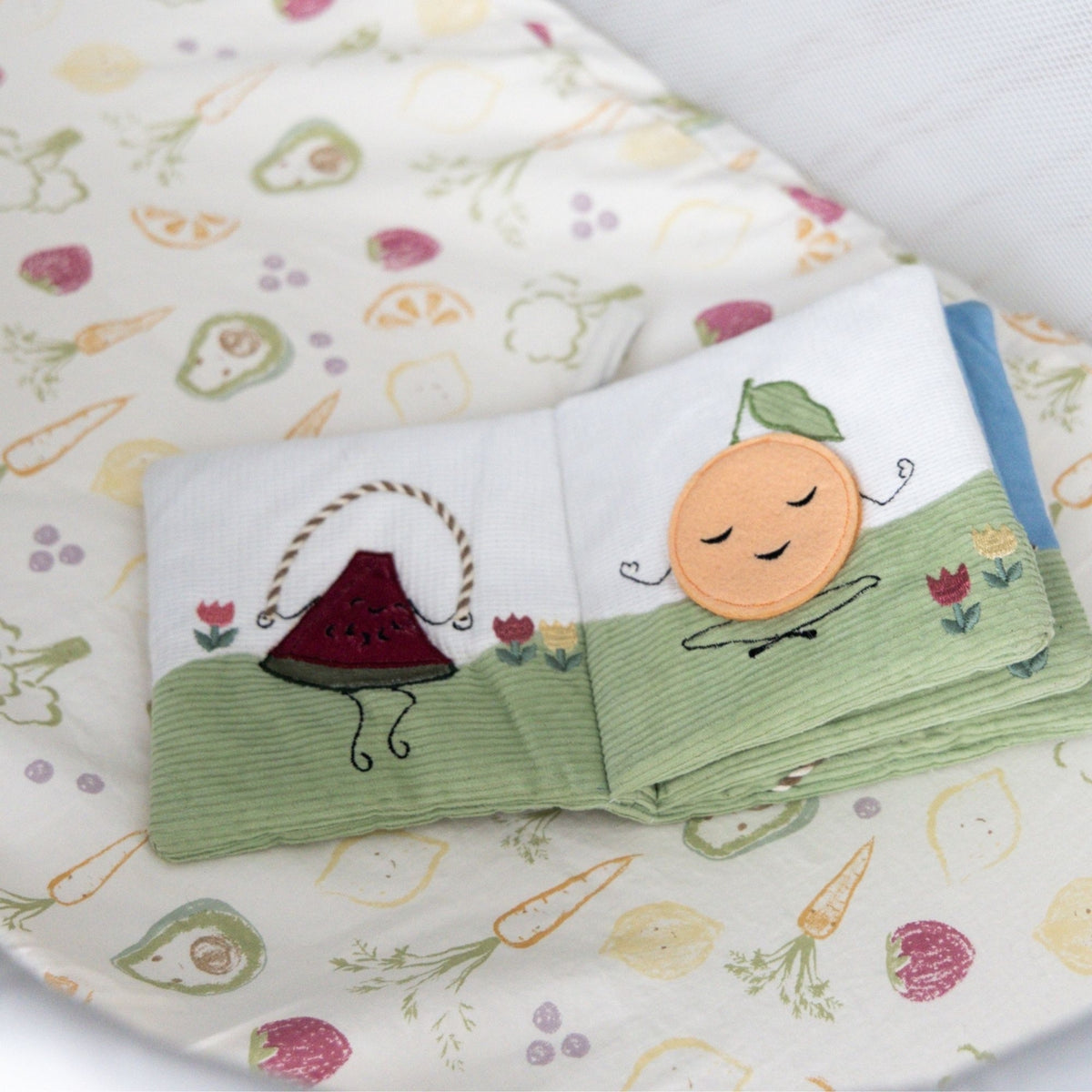 Folded children's book with cartoon characters on a fabric background