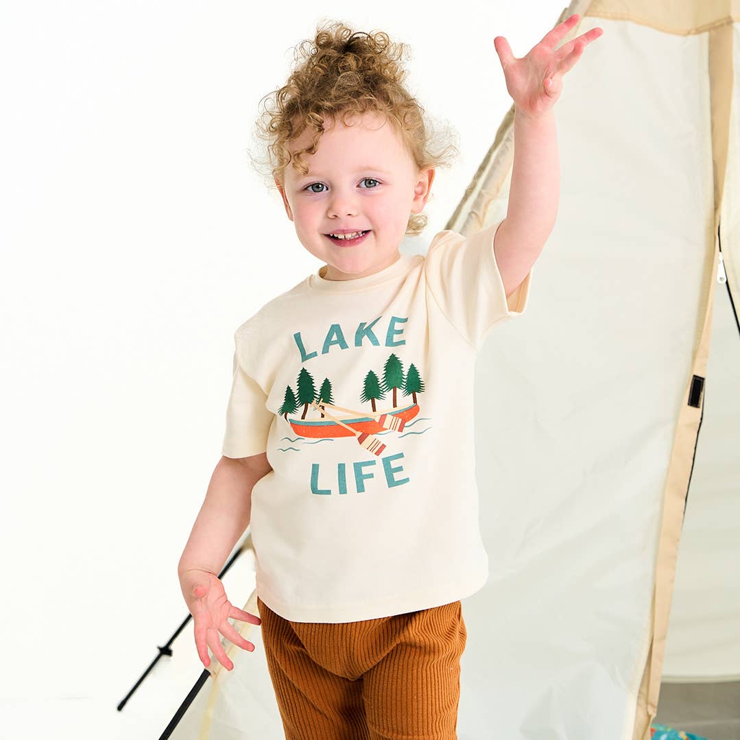 Child wearing a 'Lake Life' t-shirt with a graphic of trees and a boat.