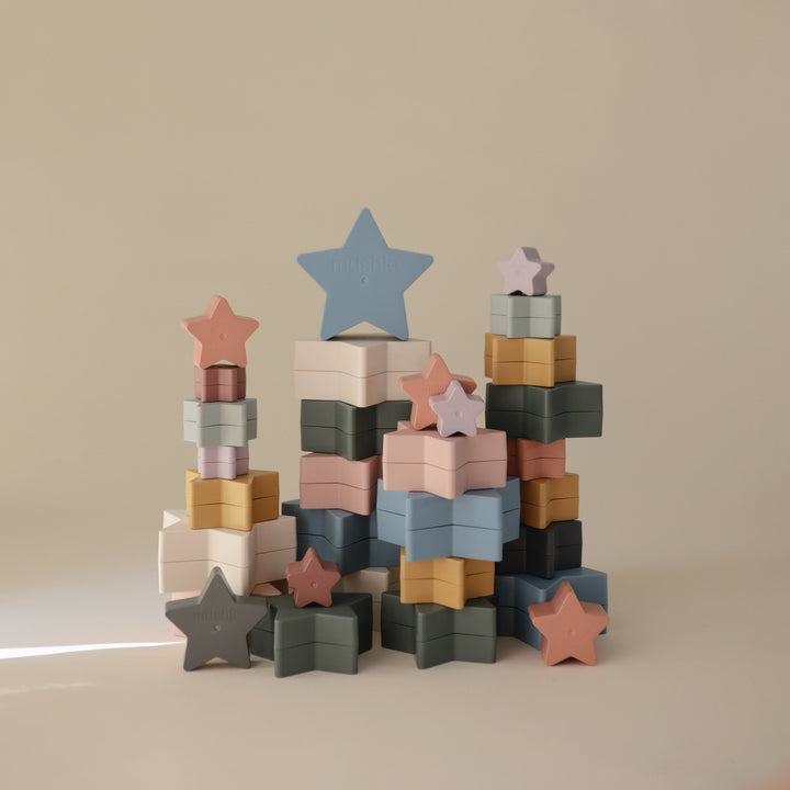 Stack of colorful star and block toys on a beige background