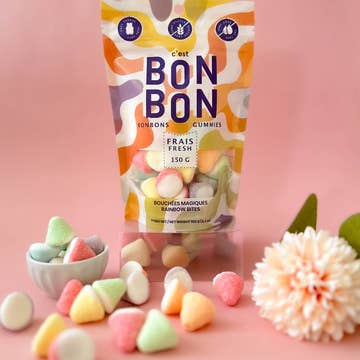 Packaging of Bon Bon gummies with colorful candies on a pink background