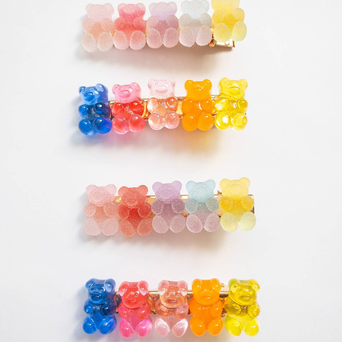 Colorful gummy bear-shaped hair clips on a white background