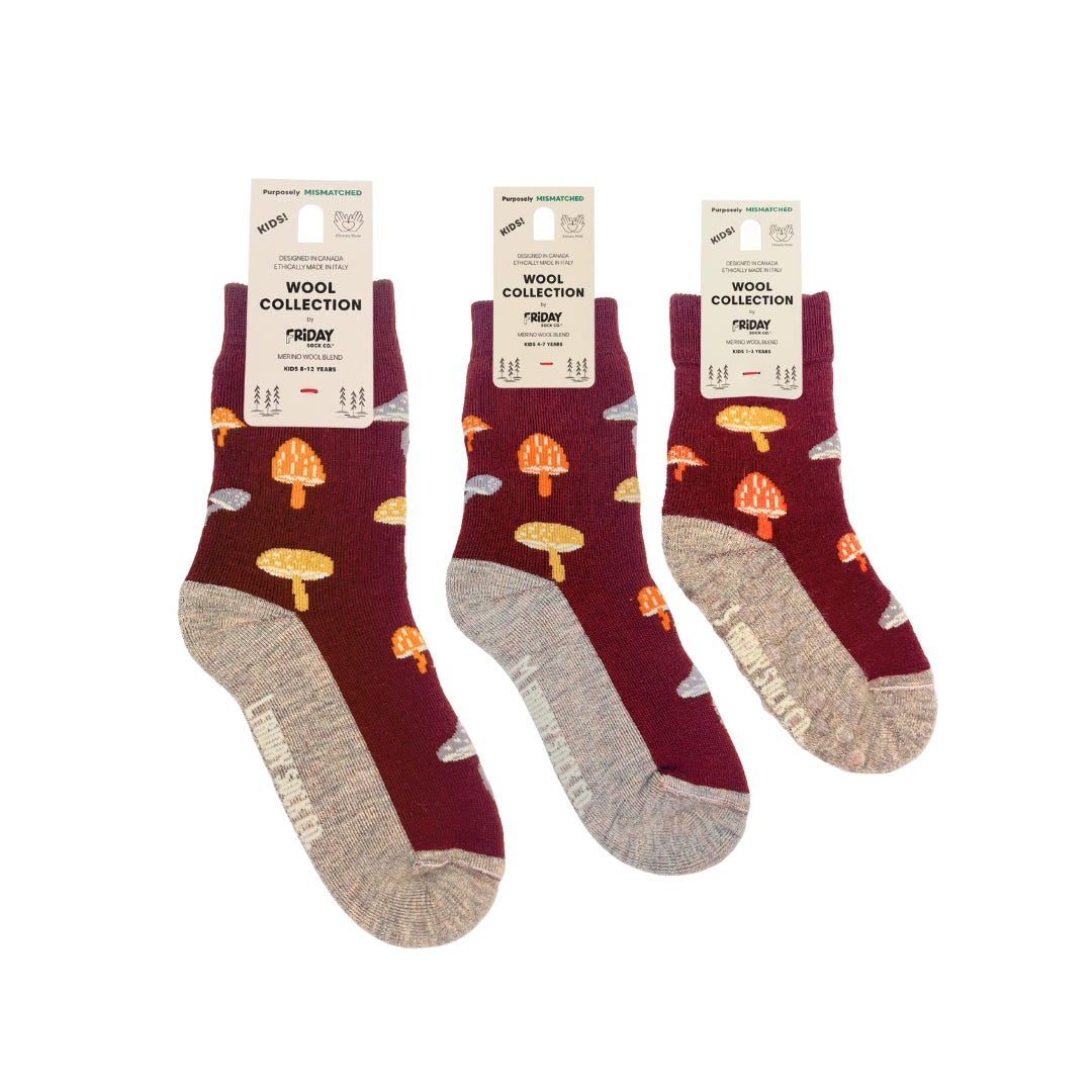 Three pairs of wool socks from the brand 'Fingertip' in their 'Wool Collection' from Norway. The socks feature a deep burgundy upper with a pattern of orange and yellow mushrooms and gray clouds, and a contrasting heather gray toe and heel.
