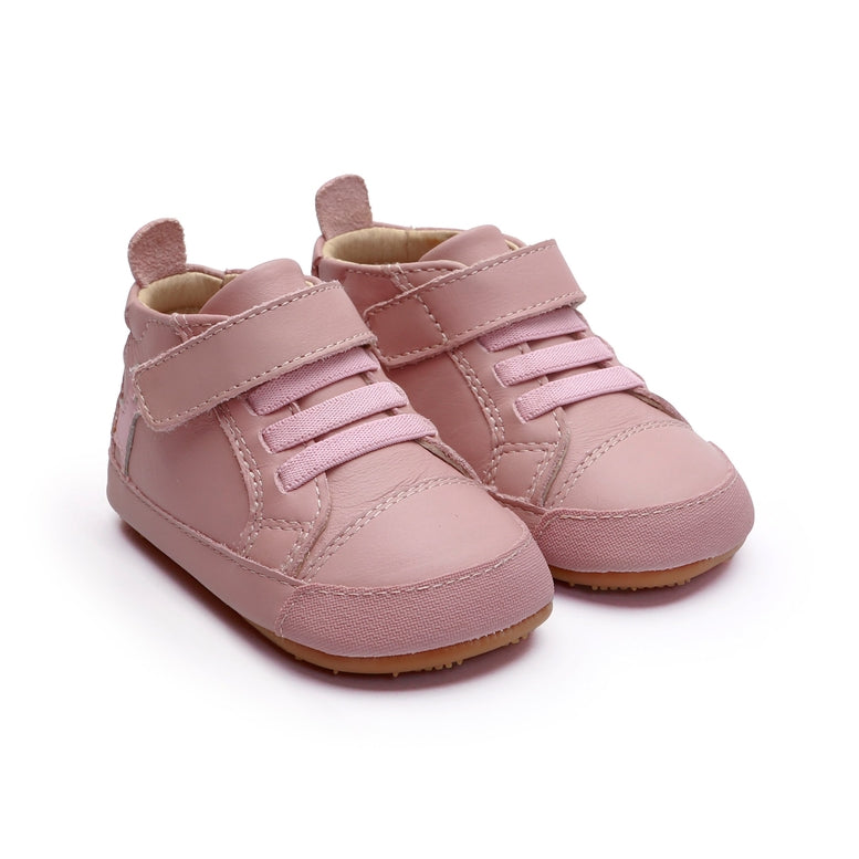 A pair of baby high-top sneakers in dusty pink faux leather, featuring adjustable hook-and-loop straps and a flexible rubber sole, shown on a white background.