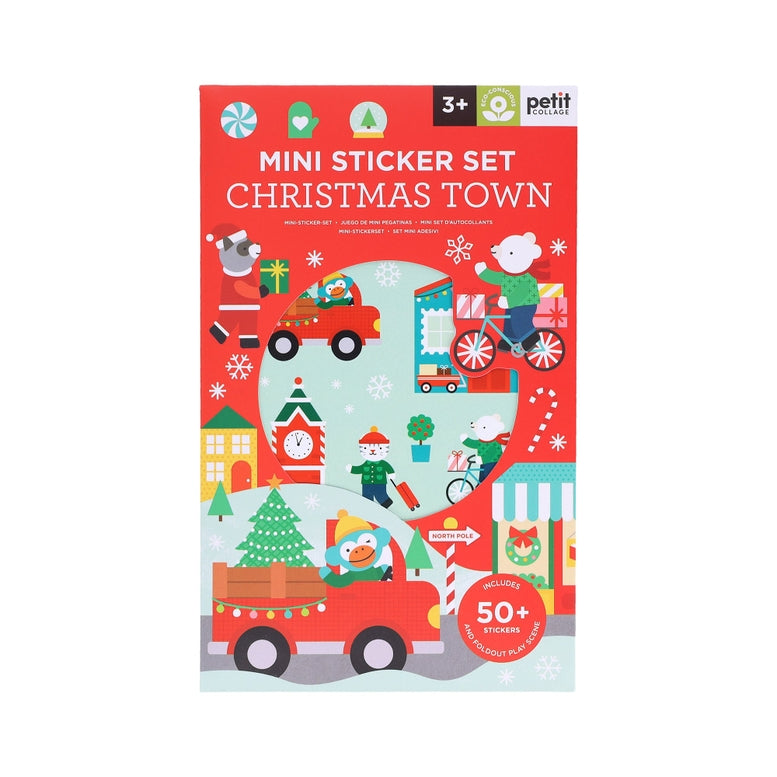 A product photo of the Christmas Town Mini Sticker Set by Petit Collage featuring festive red packaging with holiday-themed illustrations including Santa, animals, and winter scenes.