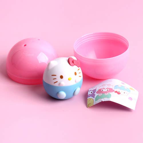 Hello Kitty-themed product with pink lid and blue body on a pink background