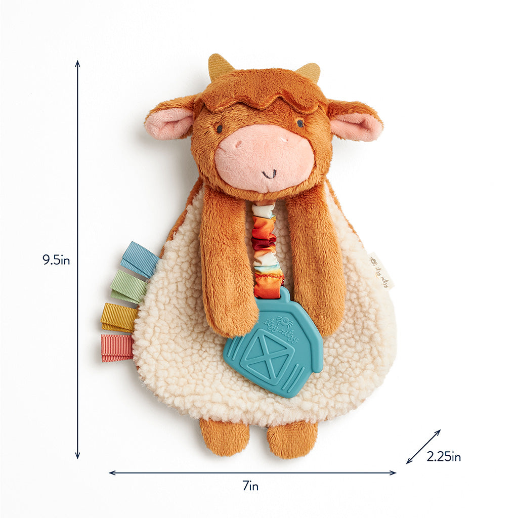 Plush toy cow with colorful elements and measurements on a white background