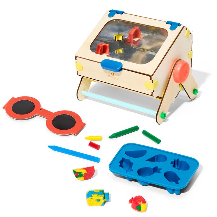 Children's educational toy set with wooden desk, colorful components, and a blue mold on a white background.