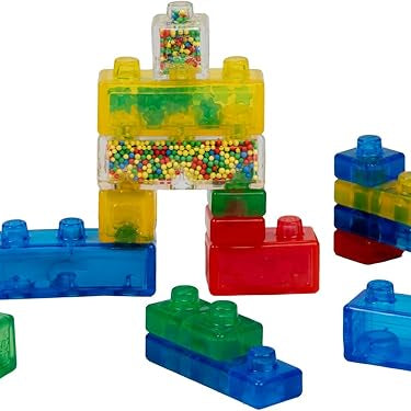 A collection of colorful, translucent Jelly Blox squishy building blocks assembled together, featuring standard bricks in red, blue, and green alongside special blocks filled with tiny colorful beads.