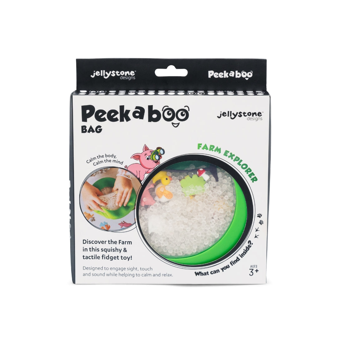 Jellystone Designs Peek a Boo Bag 'Farm Explorer' sensory fidget toy in its original white and black retail packaging, showing the green circular window with white beads and colorful farm-themed elements.
