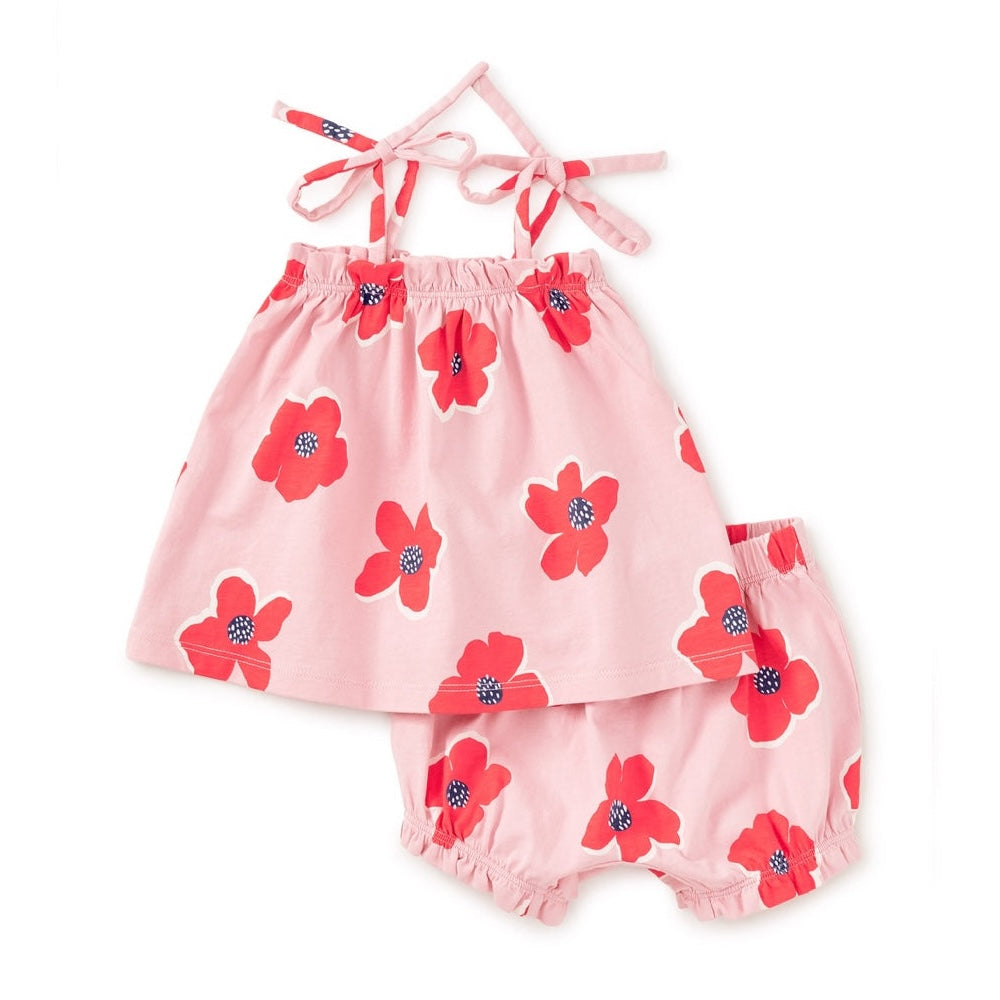 A two-piece baby outfit set consisting of a pink halter romper and matching bloomers, both printed with large red flowers and dark blue centers, displayed on a clean white background.