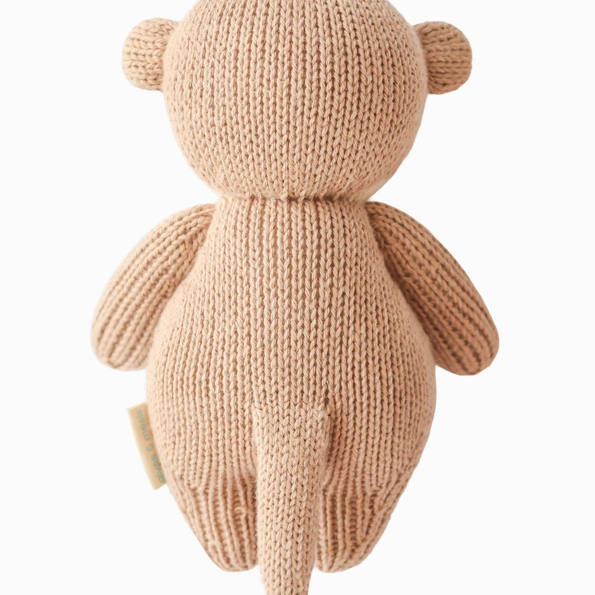 Knitted teddy bear toy on a white background