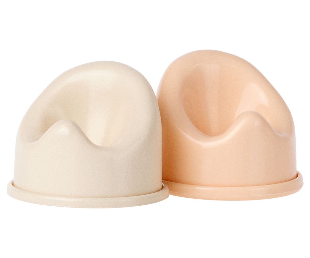 Two beige and pink plastic cups on a white background