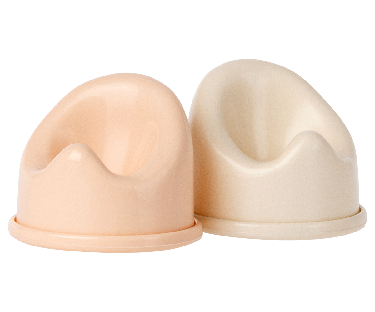 Two beige silicone cups on a white background