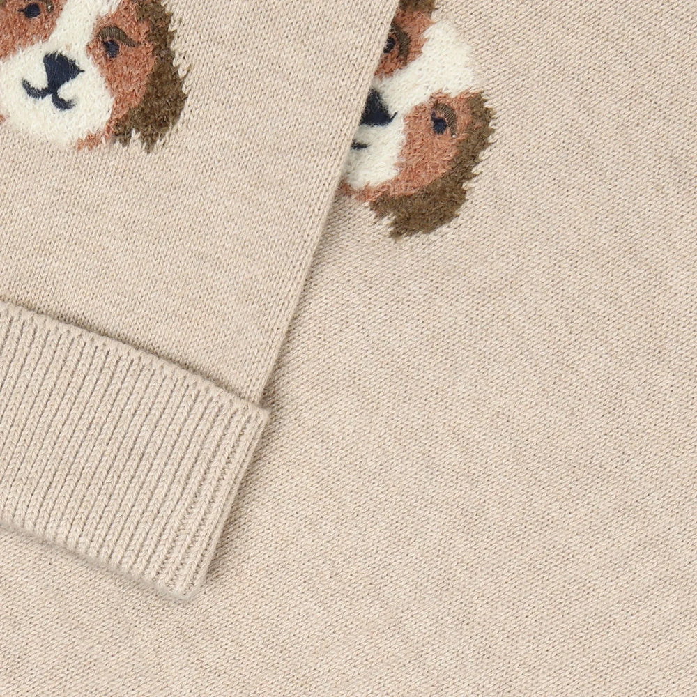 Close-up of a beige sweater with dog face pattern