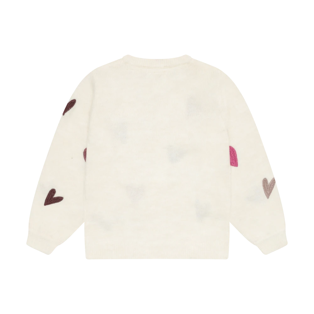 An off-white knit sweater with long sleeves, featuring an all-over pattern of small hearts in dark brown, pink, and light gray.