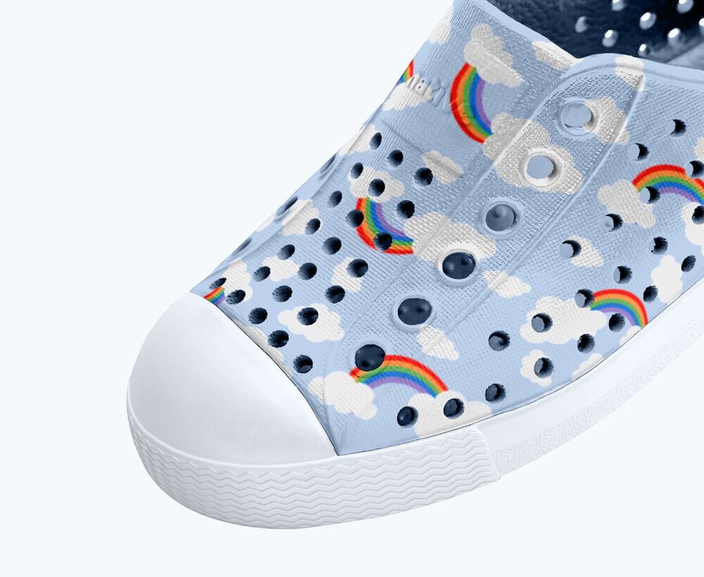 Light blue shoe with rainbow and cloud pattern on a white background