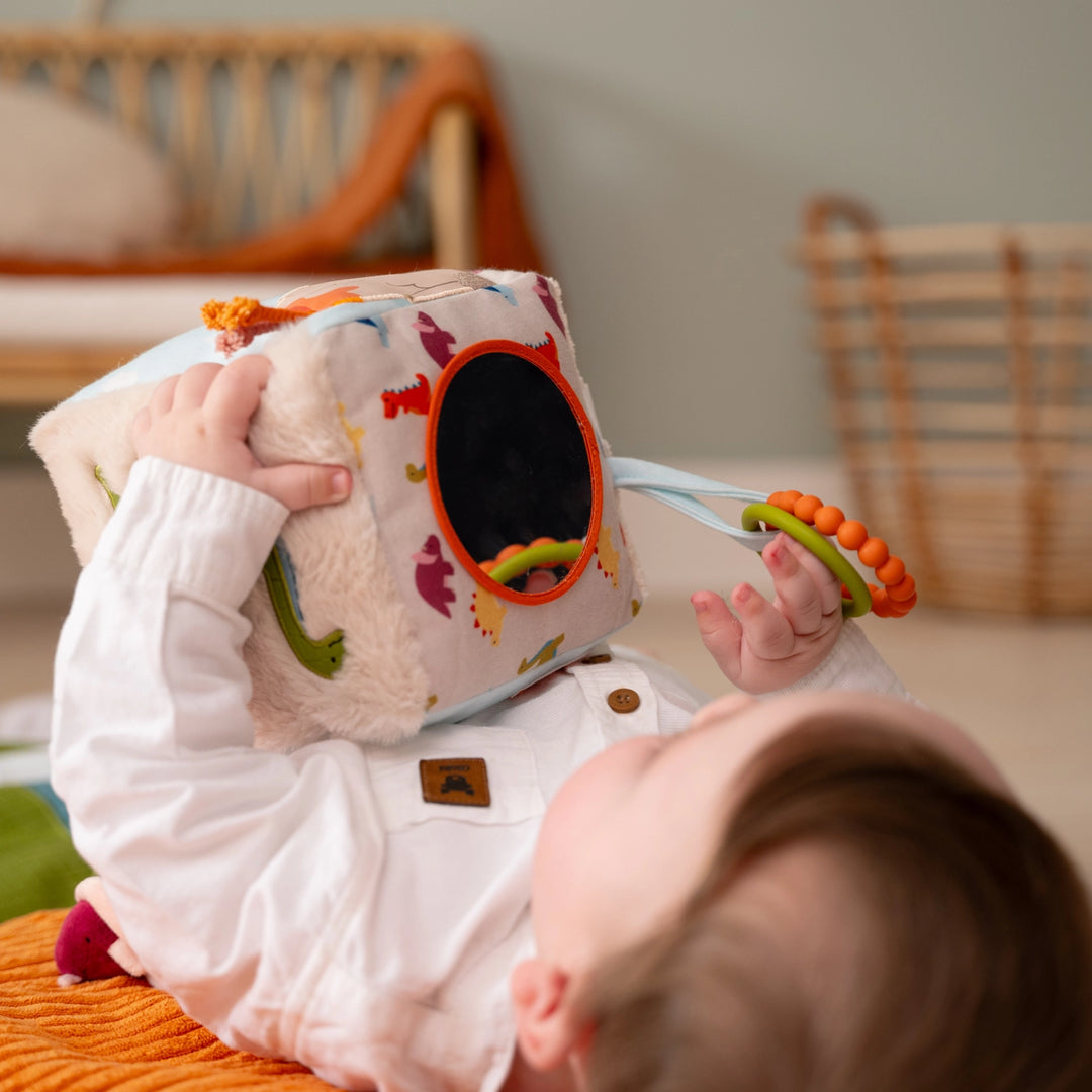 Baby playing with a colorful toy in a home setting