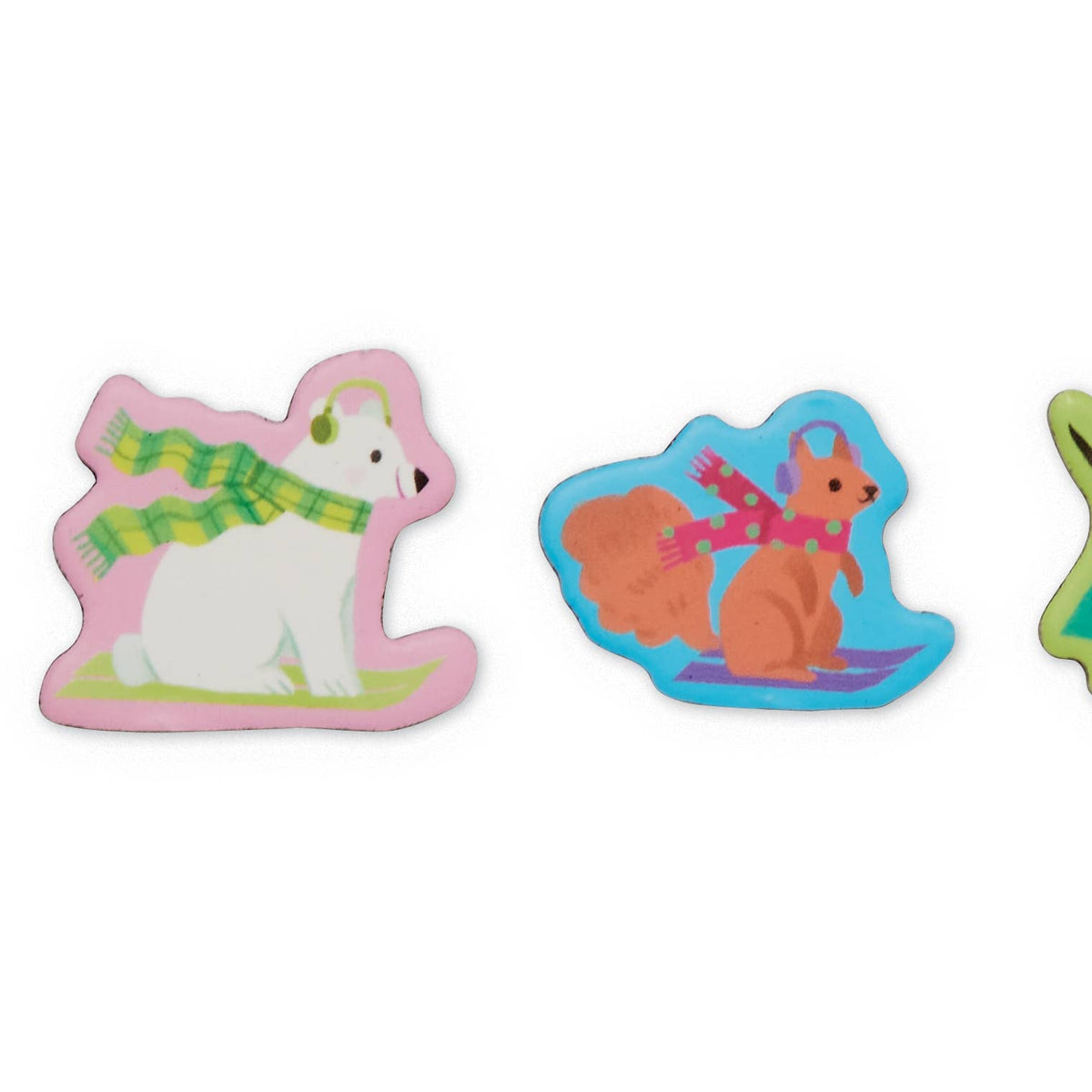 Three colorful animal-shaped items on a plain white background, including a white polar bear wearing green and yellow stripes, an orange squirrel wearing pink and purple, and part of a green animal on the right edge.