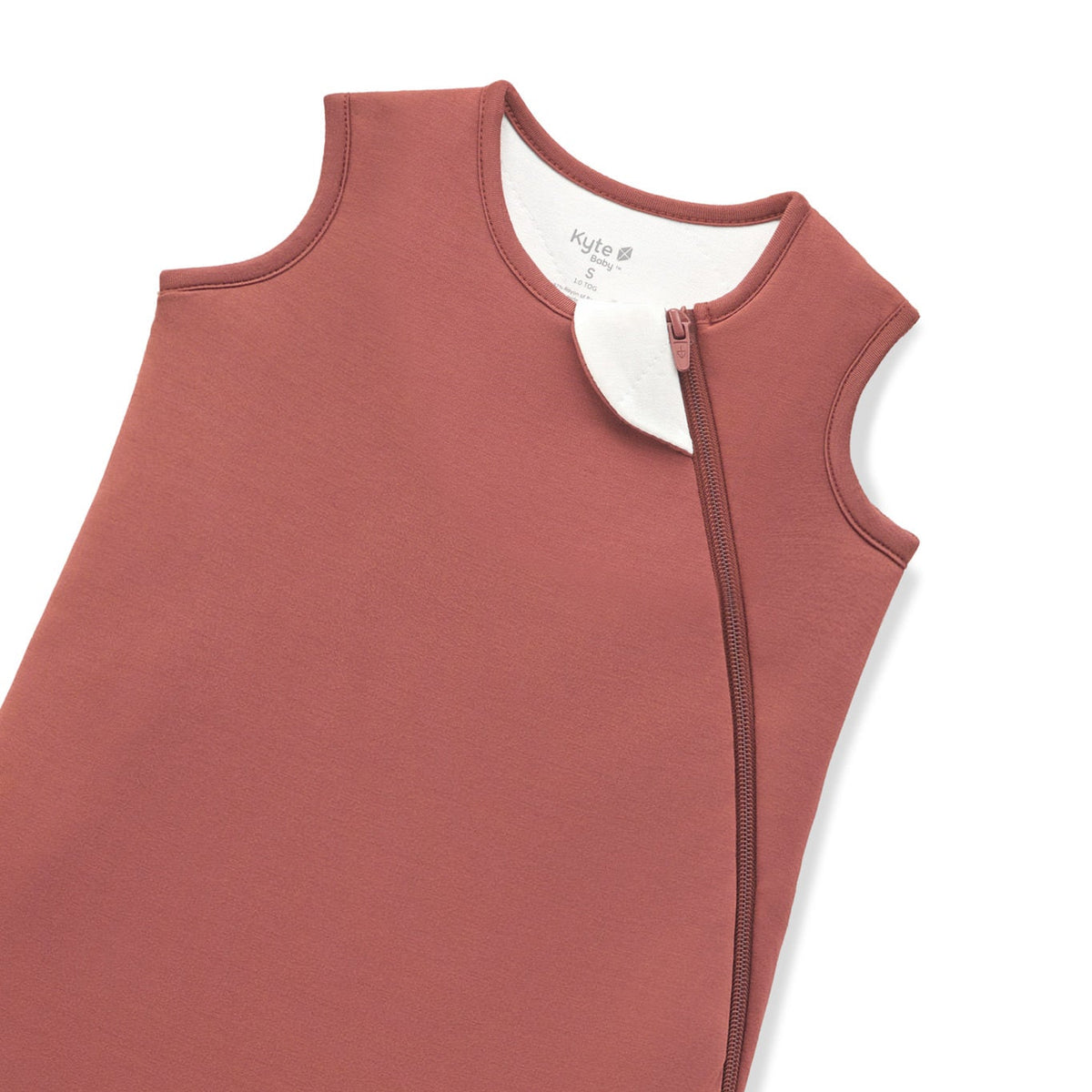 A close-up of a terracotta-colored protective cover or sleeve with zipper, shown on a plain white background.