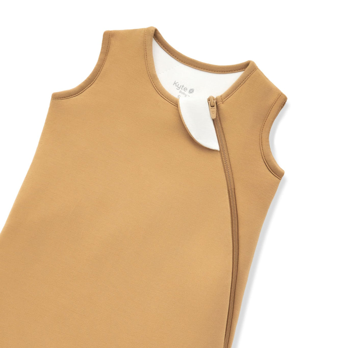 A close-up of a warm camel tan color protective cover or sleeve with zipper, shown on a plain white background.