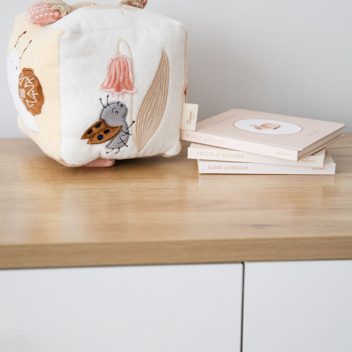 Children's soft book with illustrations on a wooden surface