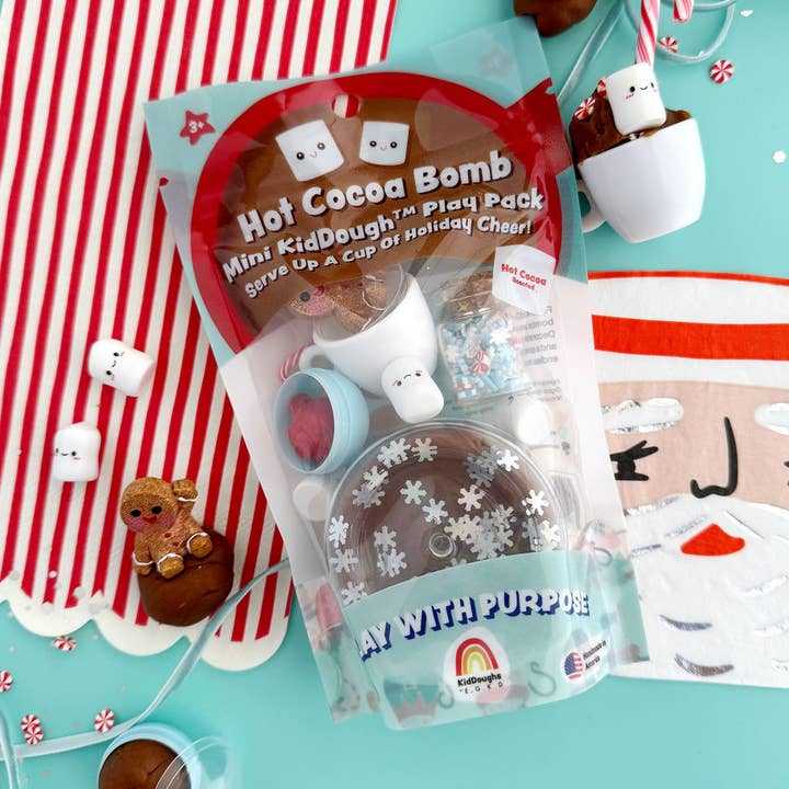 Hot Cocoa Bomb Mini KidDough Play Pack with holiday-themed items on a colorful background
