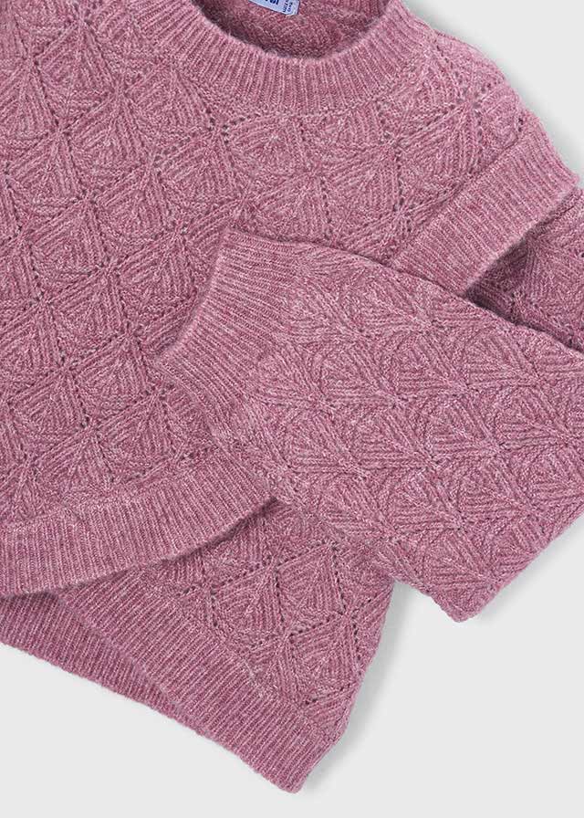 A close-up of a dusty rose pink cable-knit sweater, showing the detailed knit pattern and ribbed collar, cuffs, and hem against a white background.