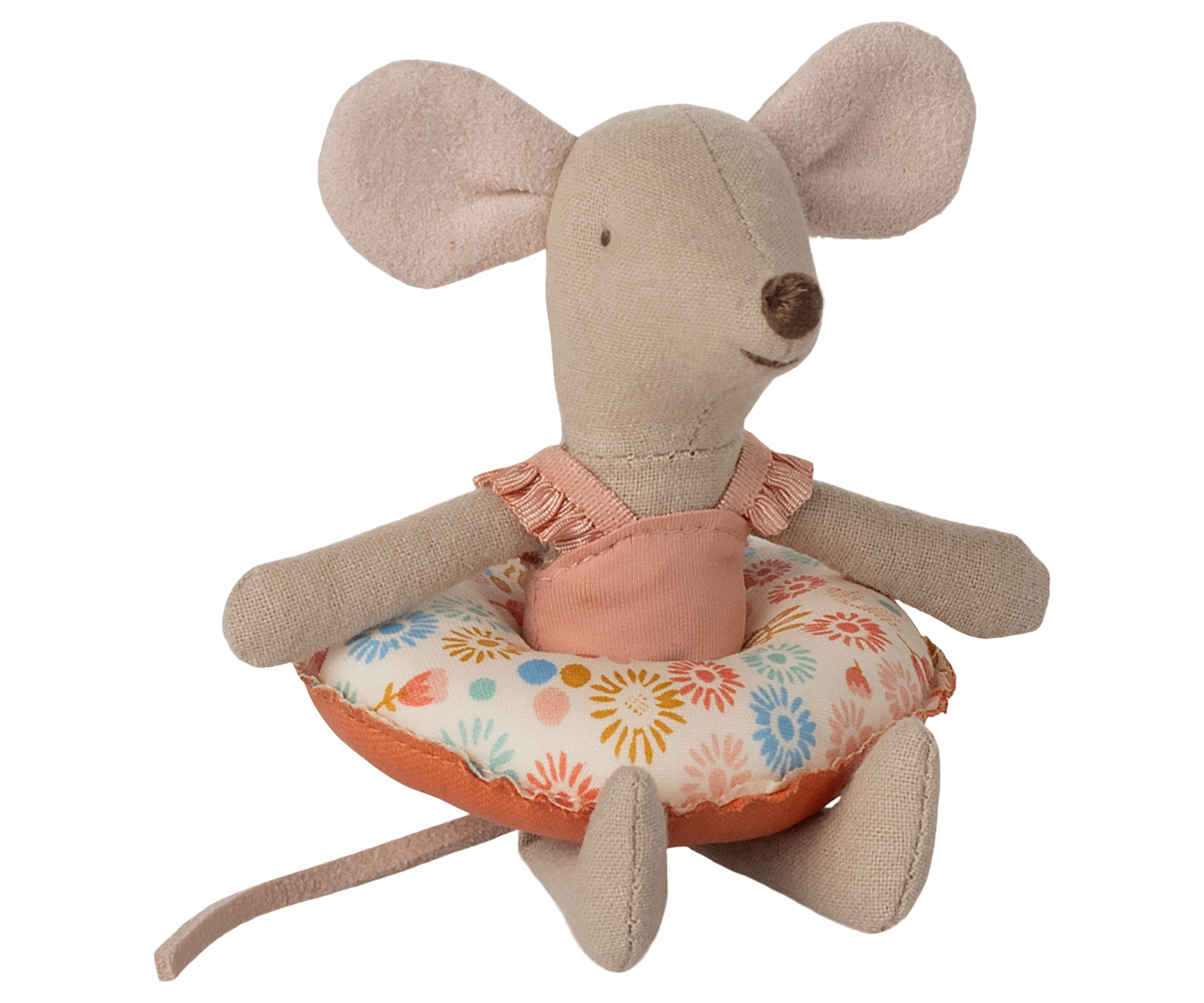 Stuffed mouse toy with a floral cushion on a white background