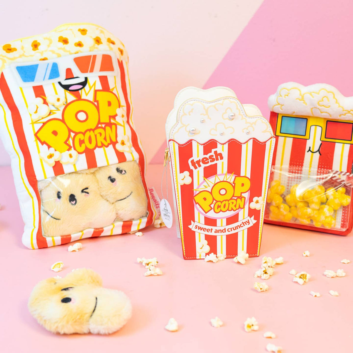 Popcorn-themed plush toys and packaging on a pink background