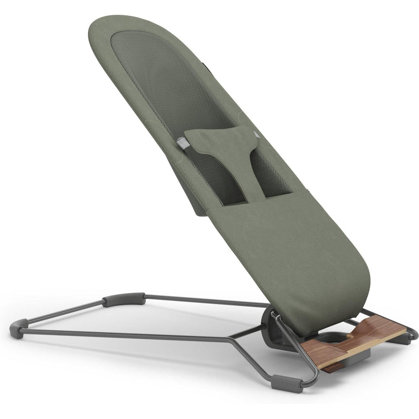An adjustable baby support seat with an olive green padded cushion and a dark gray metal stand, shown on a clean white background.