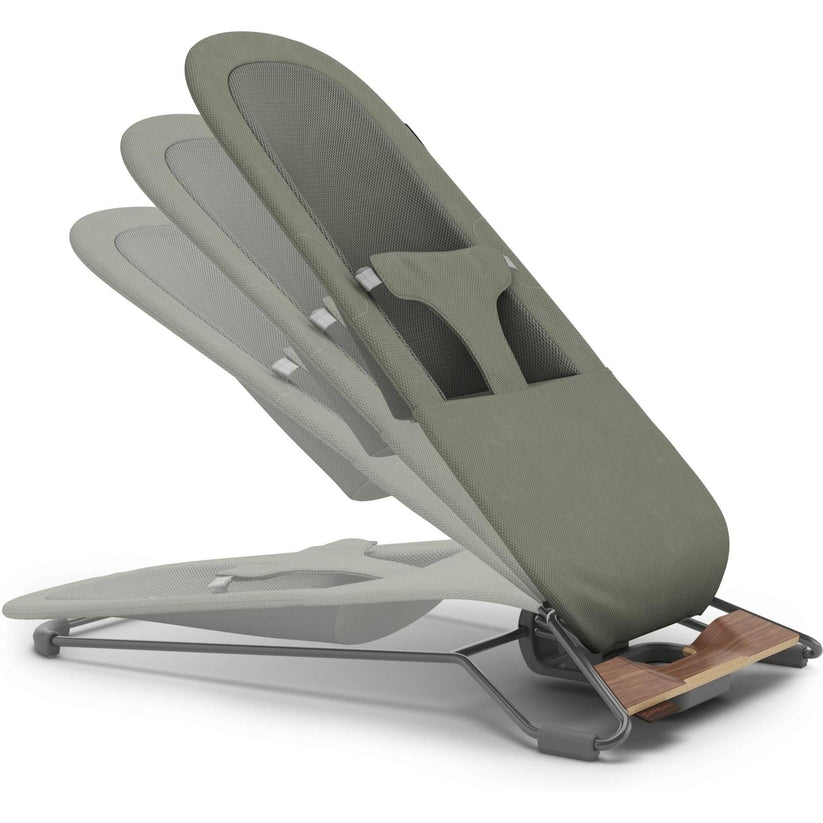 An ergonomic office chair with a gray fabric backrest, a light gray seat, and a dark gray metal frame with a wooden accent panel at the base, shown on a white background.