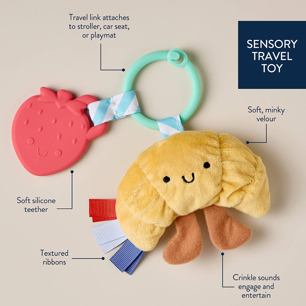 Sensory travel toy with features highlighted on a beige background