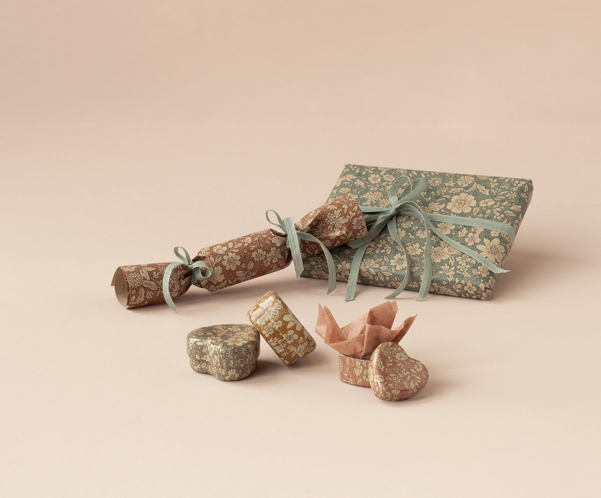 Decorative gift wrap with floral pattern on a beige background
