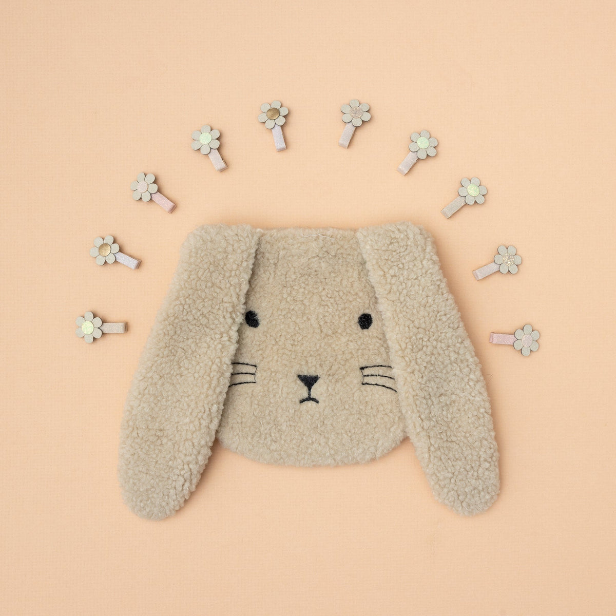 Various decorative hair clips arranged in a circular pattern on a beige background