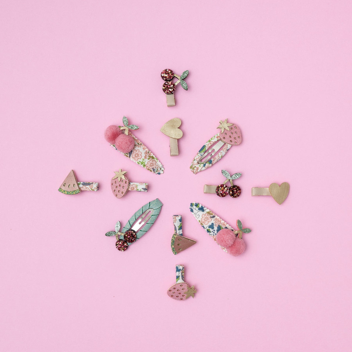 Collection of colorful hair clips on a pink background
