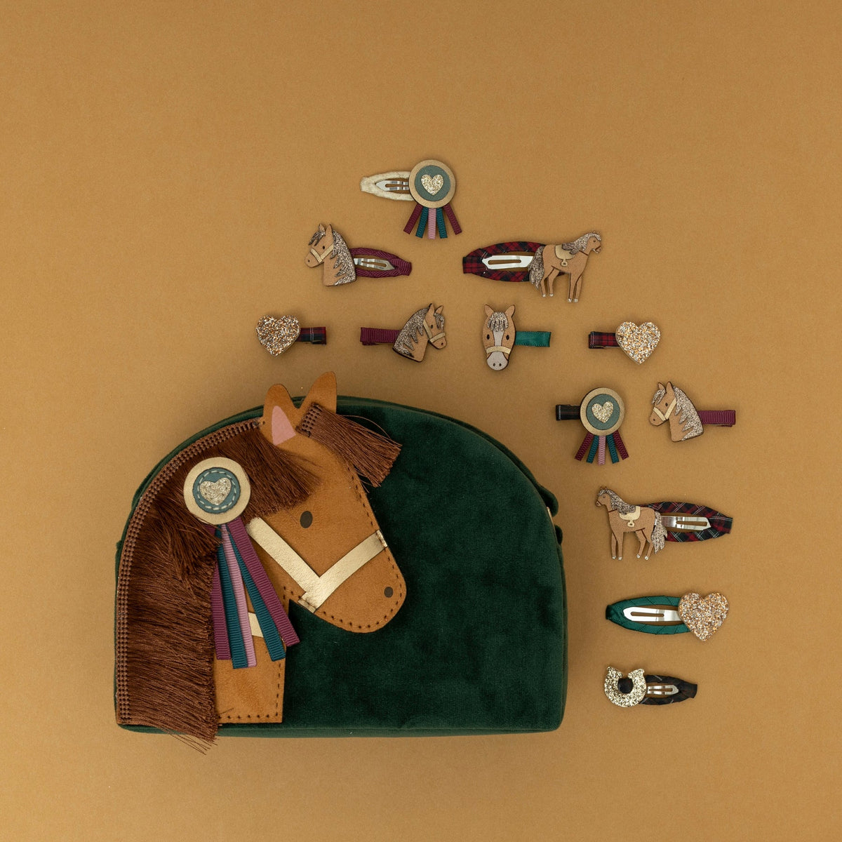 Set of horse-themed hair accessories on a brown background