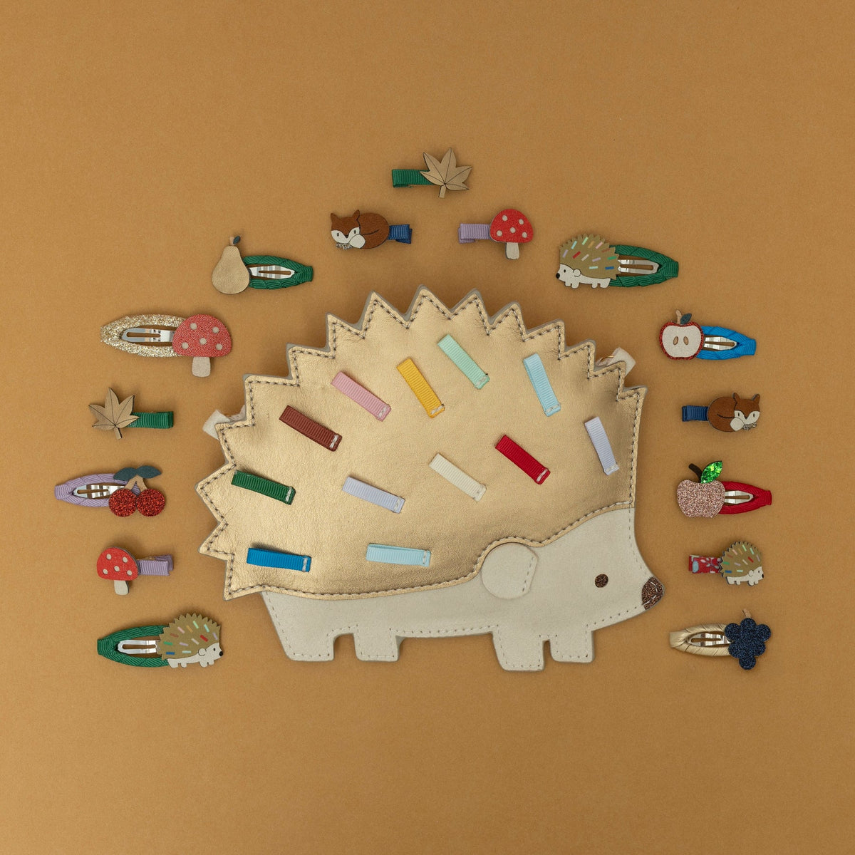 Collection of colorful hair clips shaped like animals on a brown background