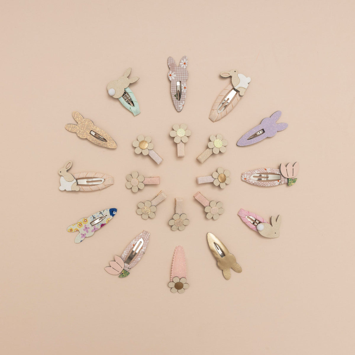 Various decorative hair clips arranged in a circular pattern on a beige background