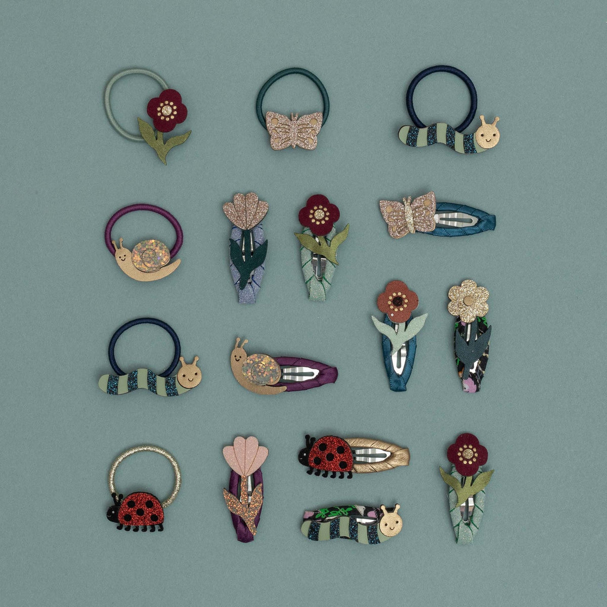 Collection of colorful hair accessories on a light blue background