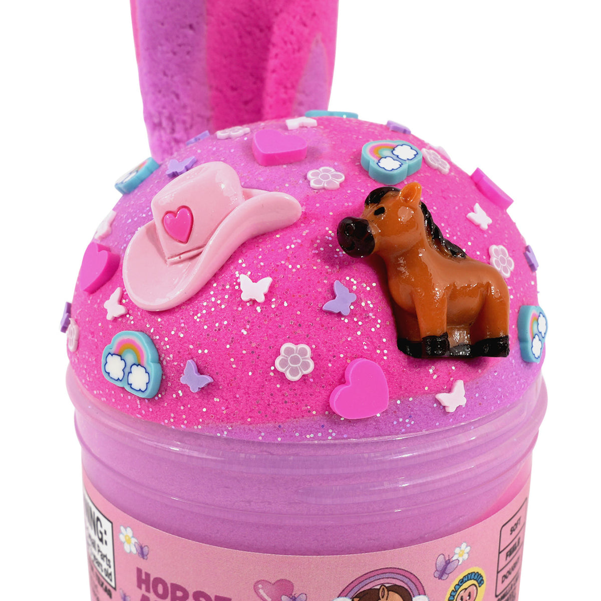 A pink slime toy container labeled 'HORSE ADVENTURE' with a small brown horse figure and decorative cowboy hat, stars, and flowers on top, shown on a white background.
