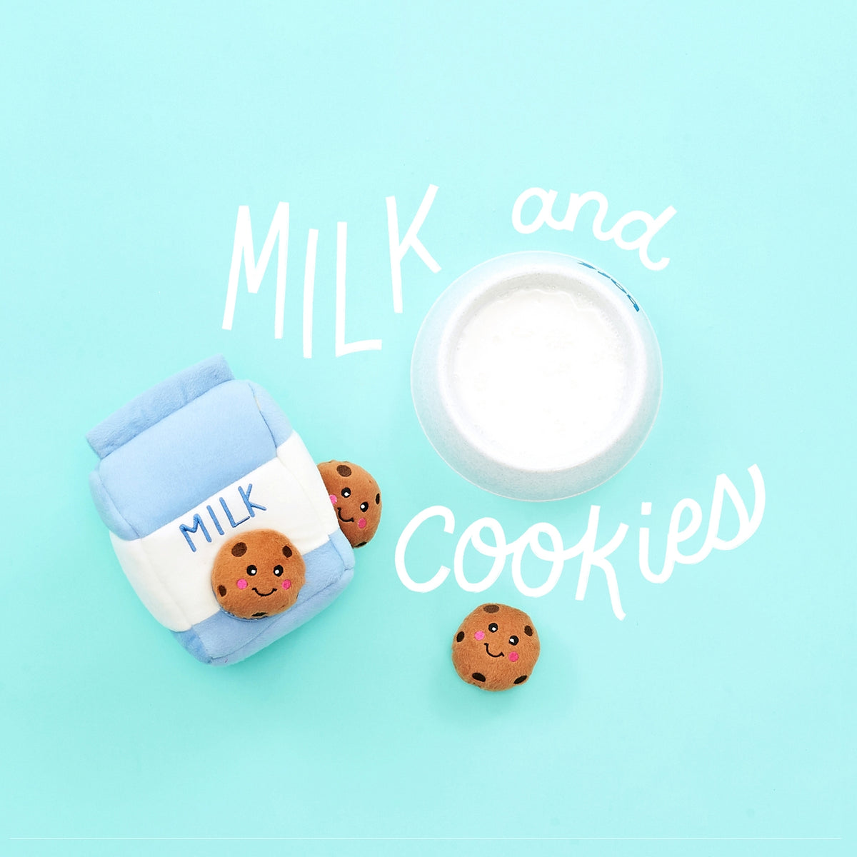 A cute flat-lay product photo of a miniature milk carton and a small open milk cup, both decorated with smiling chocolate chip cookies, on a light blue background with white hand-drawn text reading 'MILK and COOKIES'.
