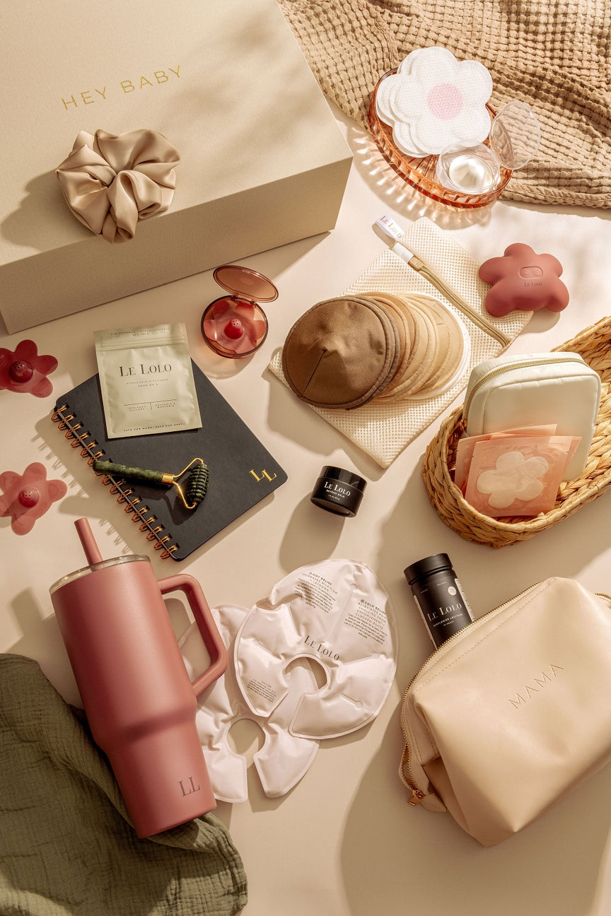 Tabletop scene with beauty products including a scrunchie, pink water bottle, and skincare items.