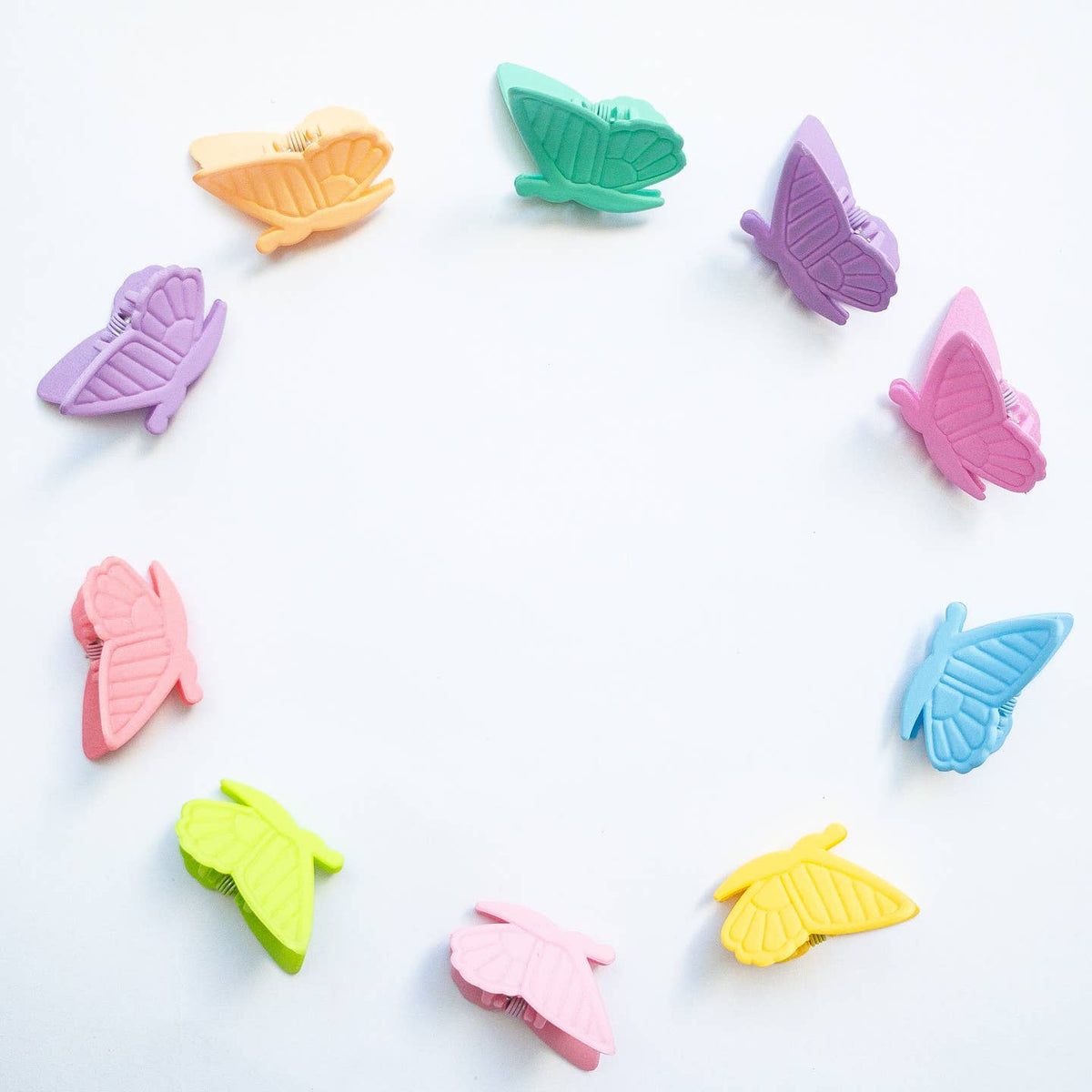 Colorful butterfly-shaped clips on a white background