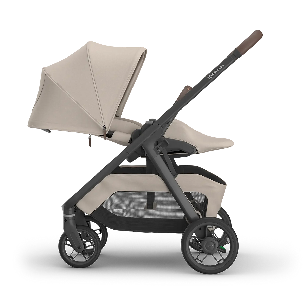 A stroller in a light beige and dark gray/black colorway, shown from a side profile on a clean white background. The stroller features a beige canopy, a matching seat liner, a dark gray frame, and brown accents on the handle grip.