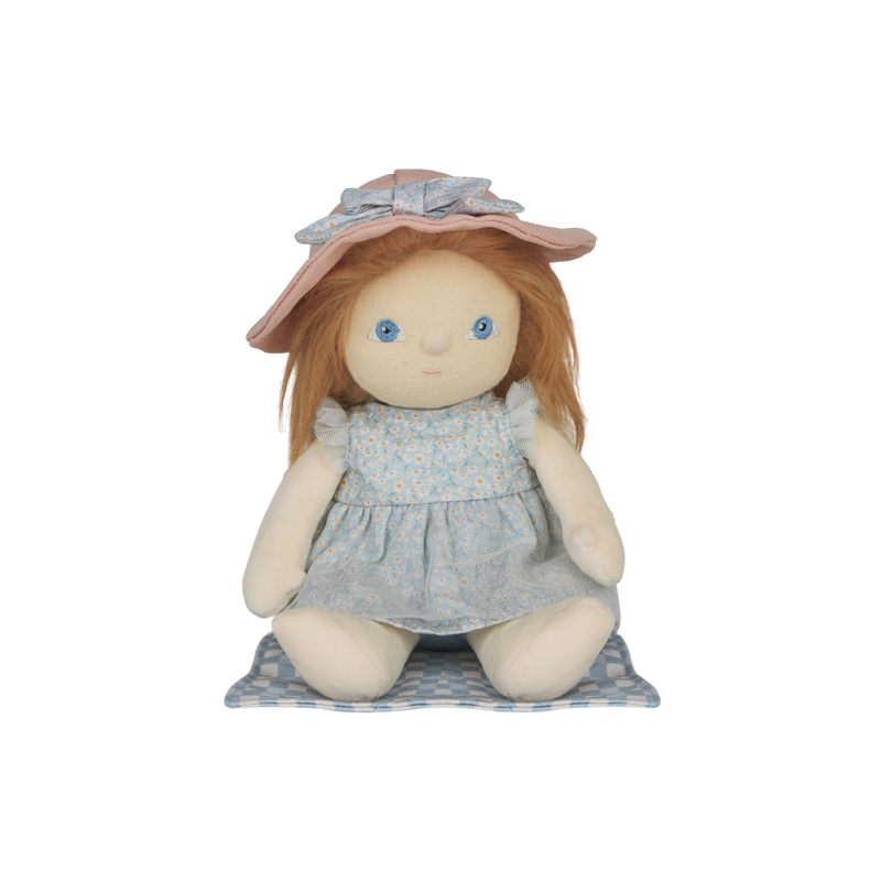 Stuffed doll with red hair, blue dress, and pink hat on a white background