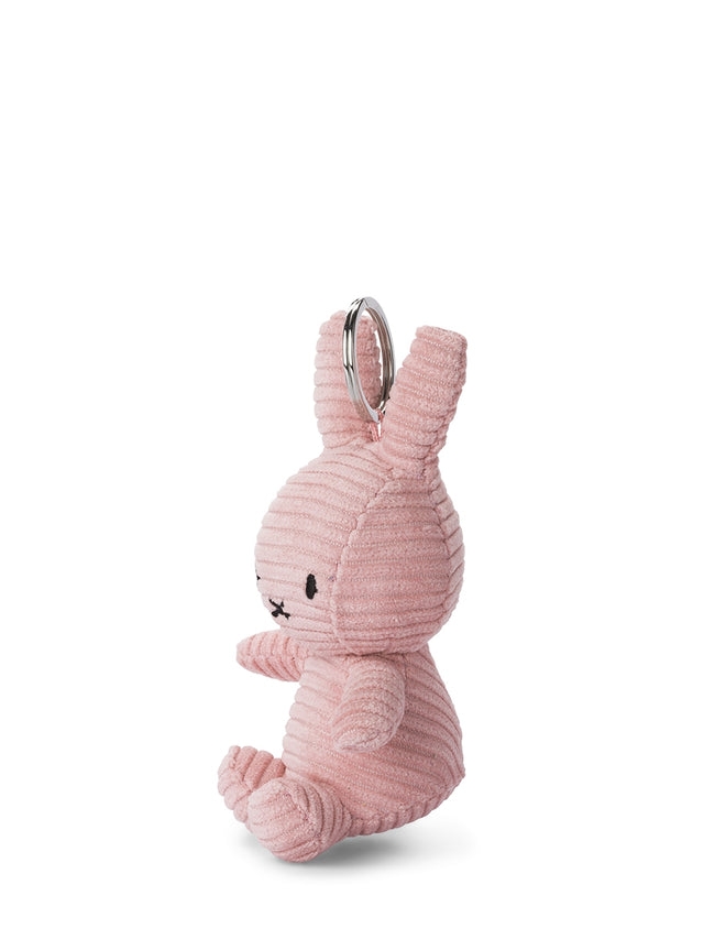 Pink bunny-shaped keychain on a white background
